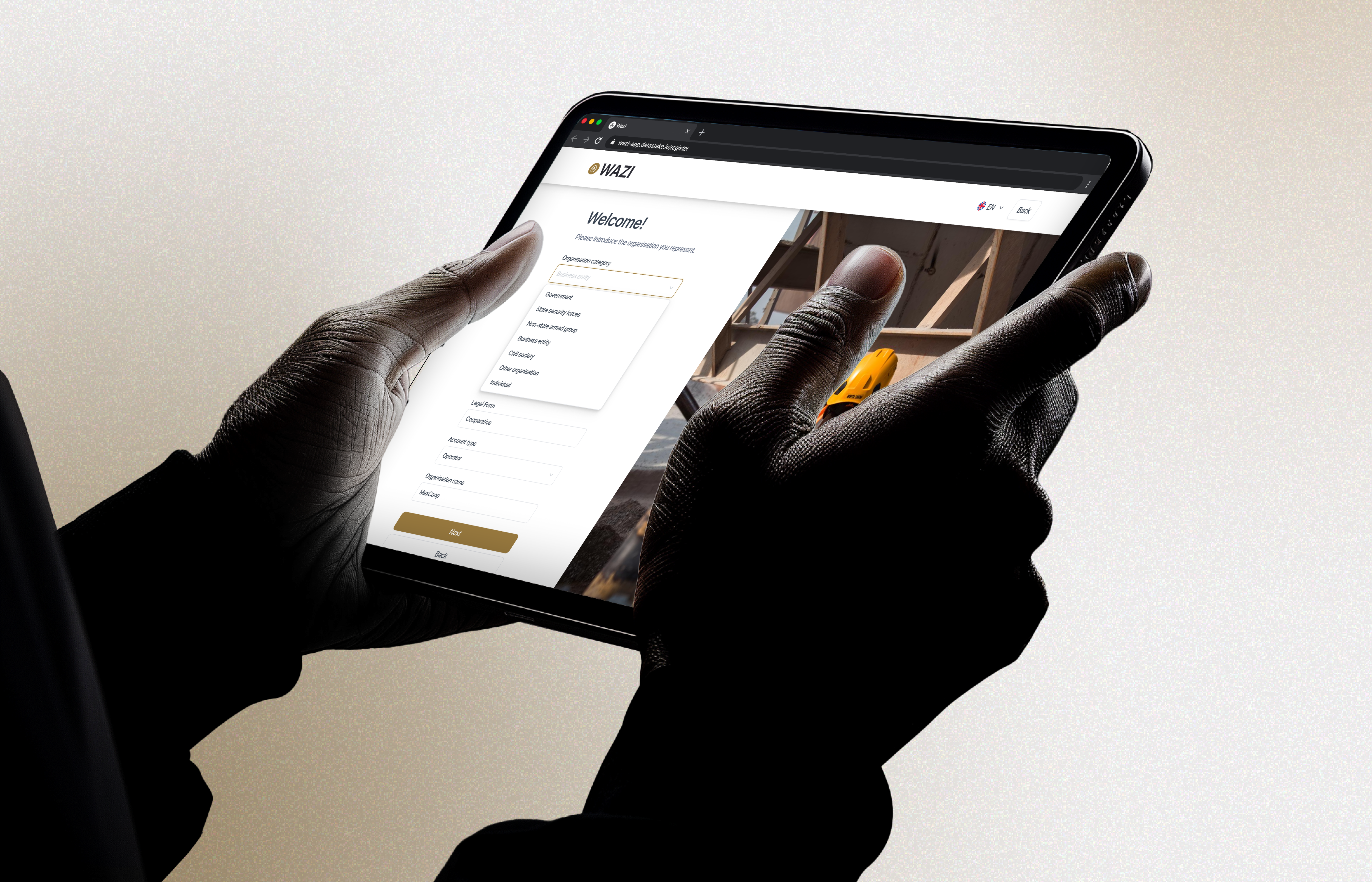 A tablet held in two hands showing the WAZI Welcome registration form, organisation category dropdown open with Government, State security forces, Non-state armed group, Business entity, Civil society, Other organisation and Individual options